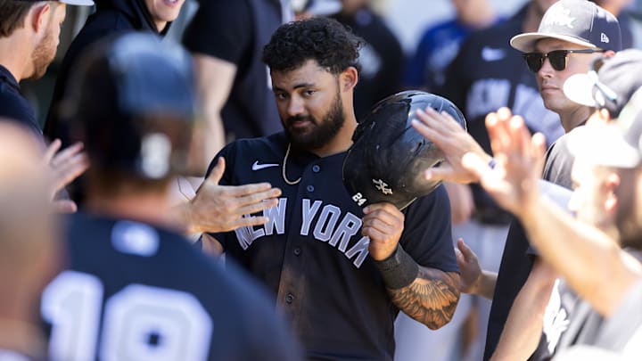 Mar 24, 2026; Mesa, Arizona, USA; New York Yankees outfielder Jasson Dominguez celebrates with teammates in the dugout after scoring against the Chicago Cubs during spring training at Sloan Park. Mandatory Credit: Mark J. Rebilas-Imagn Images