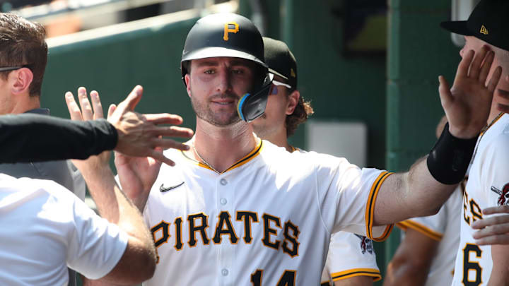 Jun 22, 2025; Pittsburgh, Pennsylvania, USA;  Pittsburgh Pirates catcher Joey Bart (14) high-fives in the dugout after scoring a run against the Texas Rangers during the fourth inning at PNC Park. Mandatory Credit: Charles LeClaire-Imagn Images