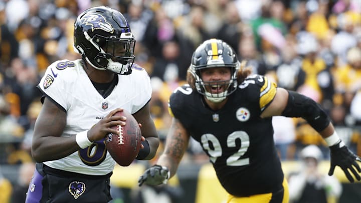 Baltimore Ravens quarterback Lamar Jackson (8) scrambles with the ball against the Pittsburgh Steelers during the fourth quarter at Acrisure Stadium.