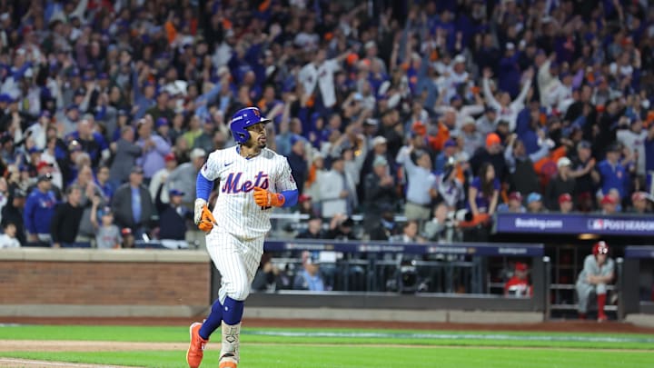 Oct 9, 2024; New York, New York, USA; New York Mets shortstop Francisco Lindor (12) hits a grand slam against the Philadelphia Phillies in the sixth inning in game four of the NLDS for the 2024 MLB Playoffs at Citi Field. Mandatory Credit: Brad Penner-Imagn Images