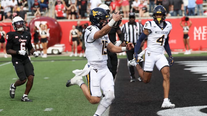 Nov 1, 2025; Houston, Texas, USA; West Virginia Mountaineers quarterback Scotty Fox Jr. (15) rushes for a touchdown against the Houston Cougars in the second half at TDECU Stadium. Mandatory Credit: Thomas Shea-Imagn Images