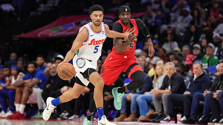 Feb 11, 2025; Philadelphia, Pennsylvania, USA; Philadelphia 76ers guard Quentin Grimes (5) drives with the ball against Toronto Raptors forward Chris Boucher (25) in the second quarter at Wells Fargo Center. Mandatory Credit: Kyle Ross-Imagn Images