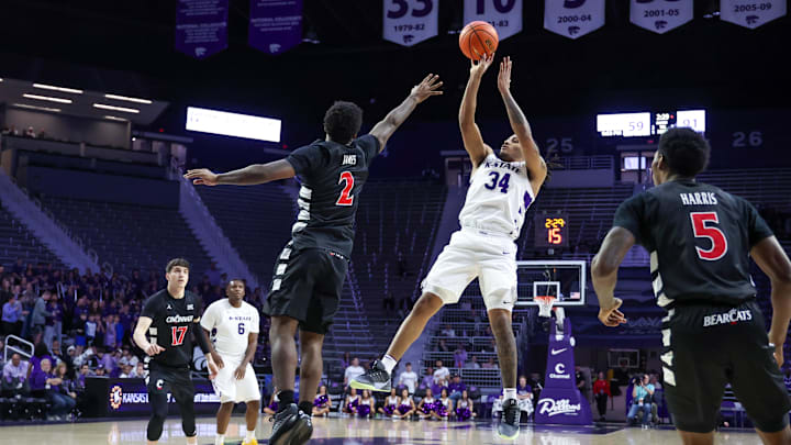 Feb 11, 2026; Manhattan, Kansas, USA; Kansas State Wildcats guard Nate Johnson (34) shoots against Cincinnati Bearcats guard Jizzle James (2) during the second half at Bramlage Coliseum. 