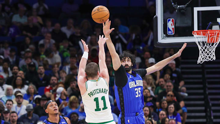 Apr 9, 2025; Orlando, Florida, USA; Boston Celtics guard Payton Pritchard (11) shoots against Orlando Magic center Goga Bitadze (35) during the second half at Kia Center. Mandatory Credit: Mike Watters-Imagn Images
