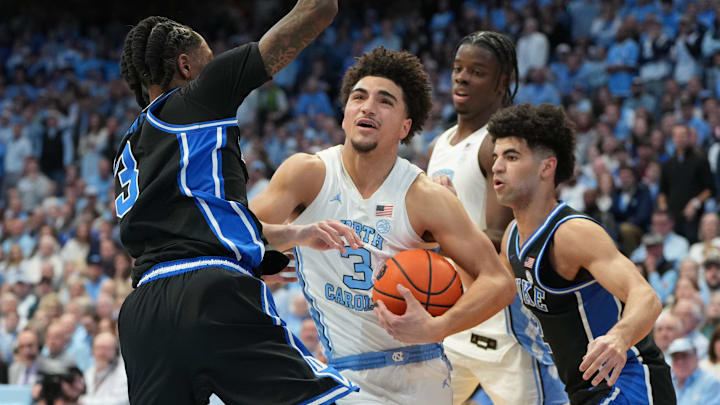 Feb 7, 2026; Chapel Hill, North Carolina, USA; North Carolina Tar Heels guard Derek Dixon (3) with the ball as Duke Blue Devils guard Isaiah Evans (3) and guard Cayden Boozer (2) defend in the second half at Dean E. Smith Center. Mandatory Credit: Bob Donnan-Imagn Images