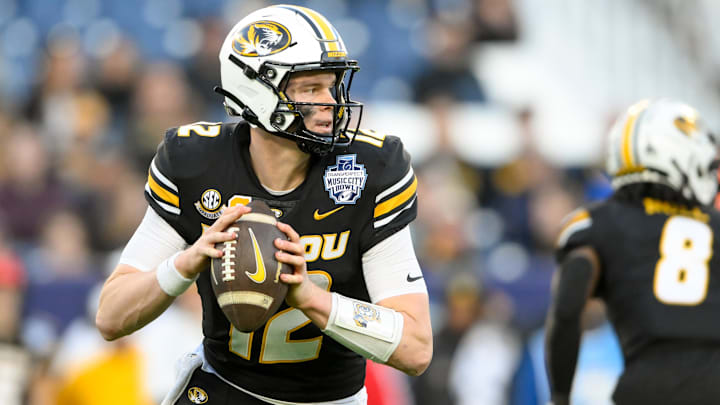 Dec 30, 2024; Nashville, TN, USA; Missouri Tigers quarterback Brady Cook (12) stands in the pocket against the Iowa Hawkeyes during the second half at Nissan Stadium. Mandatory Credit: Steve Roberts-Imagn Images Dec 30, 2024; Nashville, TN, USA; Missouri Tigers quarterback Brady Cook (12) stands in the pocket against the Iowa Hawkeyes during the second half at Nissan Stadium. Mandatory Credit: Steve Roberts-Imagn Images