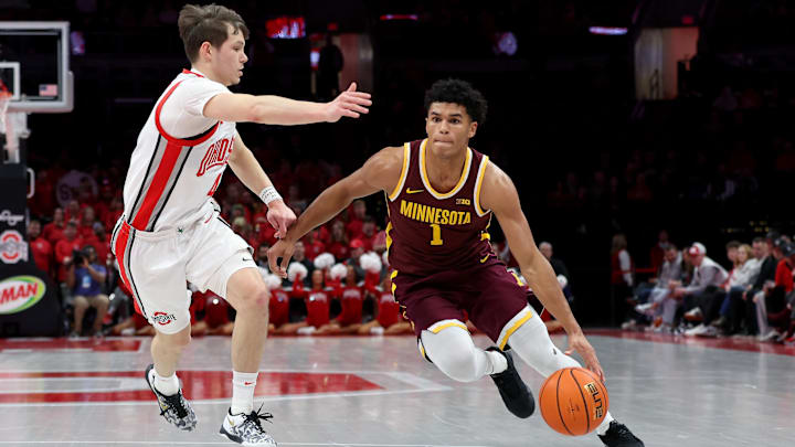 Jan 20, 2026; Columbus, Ohio, USA;  Minnesota Golden Gophers guard Isaac Asuma (1) drives to the basket as Ohio State Buckeyes guard Gabe Cupps (4) defends during the first half at Value City Arena. Mandatory Credit: Joseph Maiorana-Imagn Images