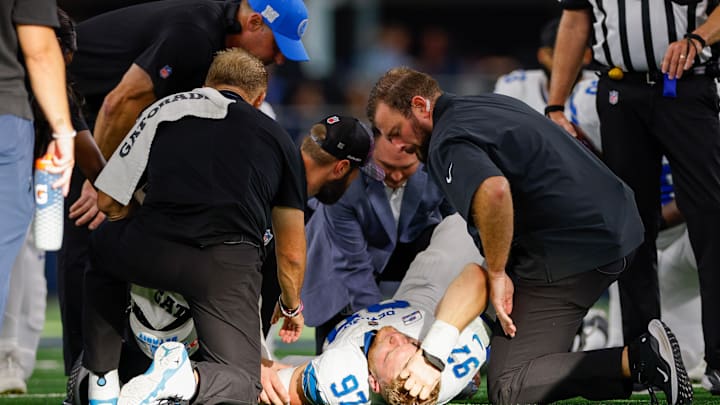 Oct 13, 2024; Arlington, Texas, USA; Detroit Lions defensive end Aidan Hutchinson (97) is injured during a sack against the Dallas Cowboys during the third quarter at AT&T Stadium. Mandatory Credit: Andrew Dieb-Imagn Images Oct 13, 2024; Arlington, Texas, USA; Detroit Lions defensive end Aidan Hutchinson (97) is injured during a sack against the Dallas Cowboys during the third quarter at AT&T Stadium. Mandatory Credit: Andrew Dieb-Imagn Images
