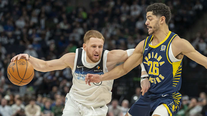 Minnesota Timberwolves guard Donte DiVincenzo dribbles the ball past Indiana Pacers guard Ben Sheppard in the first half at Target Center in Minneapolis on March 17, 2025. 