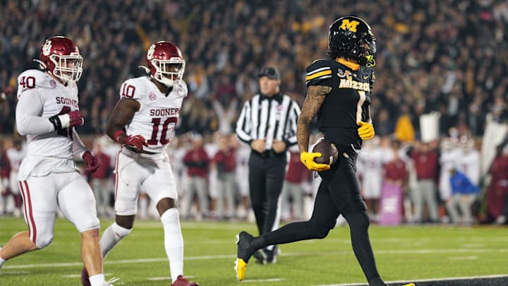 Nov 9, 2024; Columbia, Missouri, USA; Missouri Tigers wide receiver Theo Wease Jr. (1) scores a touchdown against Oklahoma Sooners defensive lineman Ethan Downs (40) and linebacker Kip Lewis (10) during the second half at Faurot Field at Memorial Stadium. Mandatory Credit: Jay Biggerstaff-Imagn Images