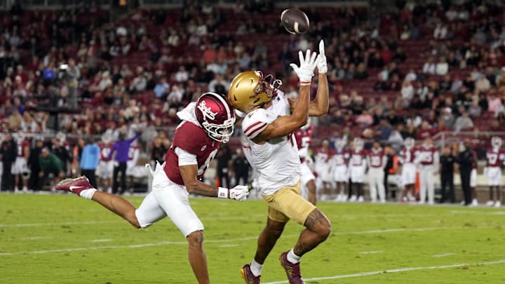 Sep 13, 2025; Stanford, California, USA; Boston College Eagles wide receiver Reed Harris (right) catches a pass against Stanford Cardinal cornerback Cam Richardson (left) during the second quarter at Stanford Stadium. Mandatory Credit: Darren Yamashita-Imagn Images