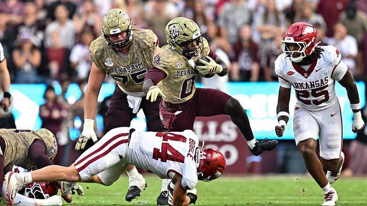 Oct 3, 2026; College Station, Texas, USA; Texas A&M Aggies running back KJ Edwards (0) runs the ball as Arkansas Razorbacks linebacker Ben Bogle (44) attempts a tackle during the first half at Kyle Field. Mandatory Credit: Maria Lysaker-Imagn Images Oct 3, 2026; College Station, Texas, USA; Texas A&M Aggies running back KJ Edwards (0) runs the ball as Arkansas Razorbacks linebacker Ben Bogle (44) attempts a tackle during the first half at Kyle Field. Mandatory Credit: Maria Lysaker-Imagn Images