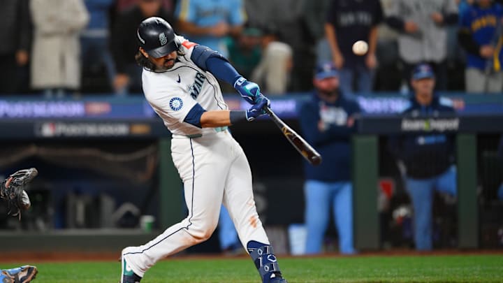 Oct 17, 2025; Seattle, Washington, USA; Seattle Mariners third baseman Eugenio Suarez (28) hits a grand slam against the Toronto Blue Jays during the eighth inning during game five of the ALCS round for the 2025 MLB playoffs at T-Mobile Park. Mandatory Credit: Steven Bisig-Imagn Images