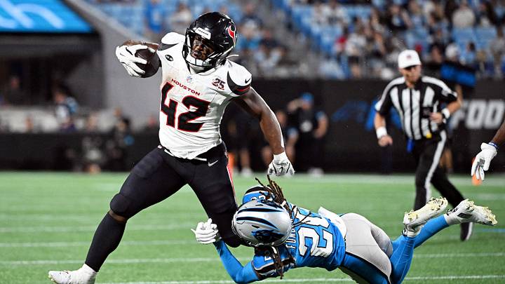 Aug 28, 2026; Charlotte, North Carolina, USA;  Houston Texans running back Owen Wright (42) runs with the ball against Carolina Panthers cornerback Tyrek Funderburk (20) during the second half at Bank of America Stadium.  Mandatory Credit: Bob Donnan-Imagn Images     TPX IMAGES OF THE DAY