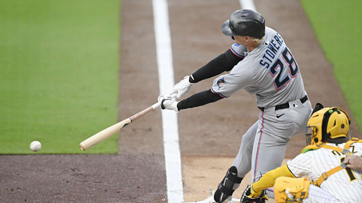 San Diego, California, USA; Miami Marlins outfielder Kyle Stowers (28) hits an RBI single during the first inning against the San Diego Padres at Petco Park.