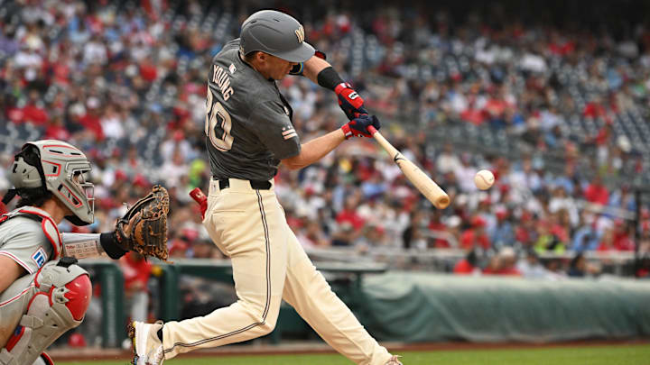 Sep 29, 2024; Washington, District of Columbia, USA; Washington Nationals center fielder Jacob Young (30) hits the ball into play against the Philadelphia Phillies during the fifth inning at Nationals Park. 