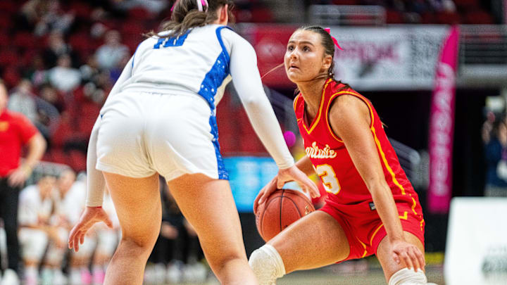 Carlisle's Macy Comito (23) looks to the basket as she dribbles the ball against Clear Creek Amana's Averie Lower (10) on March 3, 2026, at Casey’s Center in Des Moines.