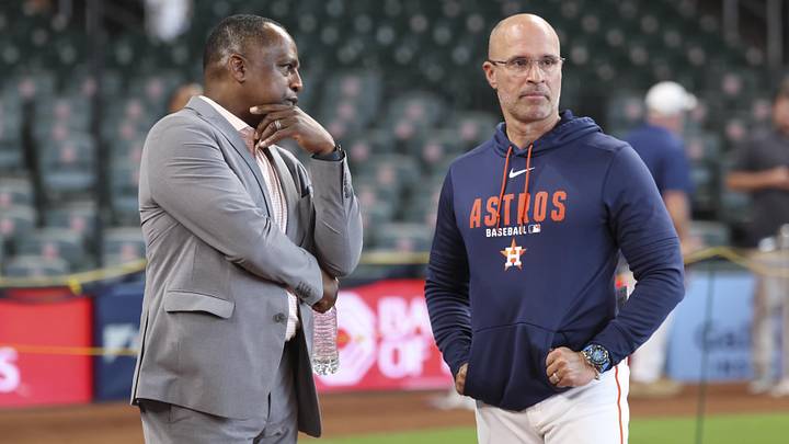 Houston Astros general manager Dana Brown (left) talks with manager Joe Espada 