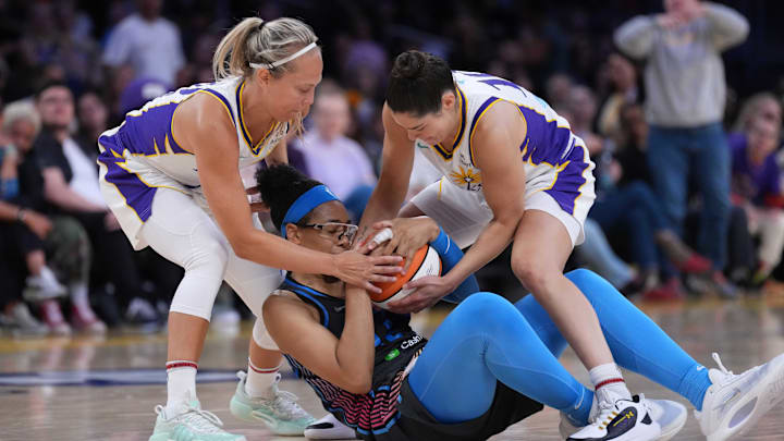 May 27, 2025; Los Angeles, California, USA; Atlanta Dream guard Allisha Gray (15) battles for the ball with LA Sparks guard Julie Allemand (20) and guard Kelsey Plum (10) in the second half  at Crypto.com Arena. Mandatory Credit: Kirby Lee-Imagn Images