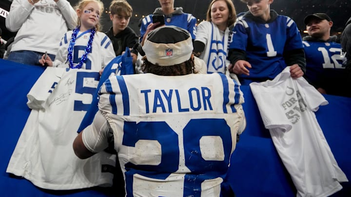 Indianapolis Colts running back Jonathan Taylor (28) signs autographs for fans Sunday, Dec. 22, 2024, after winning a game against the Tennessee Titans at Lucas Oil Stadium in Indianapolis.