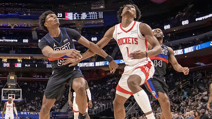 Jan 12, 2024; Detroit, Michigan, USA; Detroit Pistons forward Ausar Thompson (9) battles for for the ball with his twin brother Houston Rockets forward Amen Thompson (1) during the first half at Little Caesars Arena. Mandatory Credit: David Reginek-Imagn Images