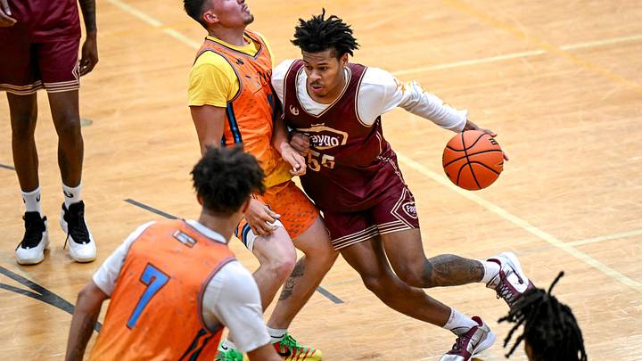 Team Faygo’s and Michigan State's Jasiah Jervis, right, moves the ball against Team Tri-Star’s Devan Wilson during the Moneyball Pro-Am on Thursday, June 25, 2026, at Holt High School.