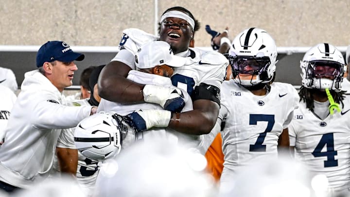Penn State Nittany Lions offensive lineman Anthony Donkoh hugs interim head coach Terry Smith after a win over Michigan State.