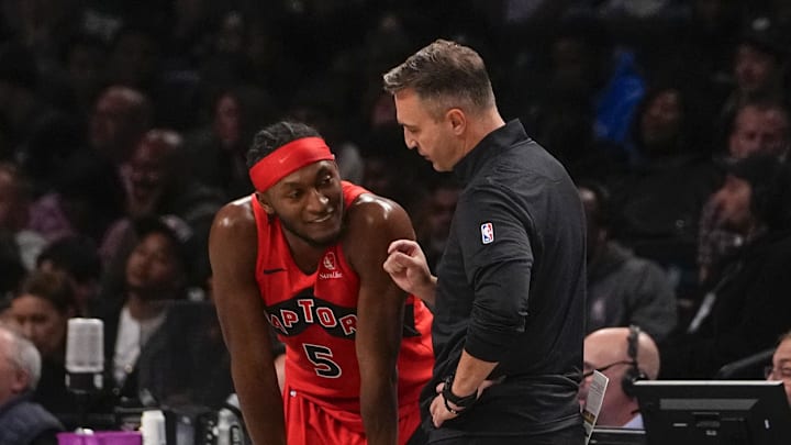 Oct 18, 2024; Brooklyn, New York, USA; Toronto Raptors head coach Darko Rajakovic speaks with Toronto Raptors shooting guard Immanuel Quickley (5) during the second half against the Brooklyn Nets at Barclays Center. Mandatory Credit: Gregory Fisher-Imagn Images