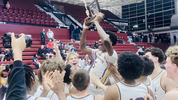 Andrew Hilman holds up the CCS Open Division hardware after a 64-38 win over St. Ignatius at Santa Clara University's Leavey Center on 2/28/2025