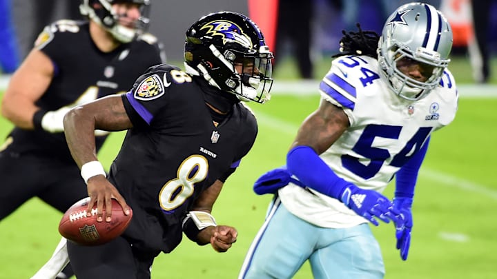 Dec 8, 2020; Baltimore, Maryland, USA; Baltimore Ravens quarterback Lamar Jackson (8) runs away from Dallas Cowboys linebacker Jaylon Smith (54) in the first quarter at M&T Bank Stadium. Mandatory Credit: Evan Habeeb-Imagn Images