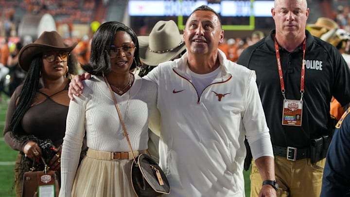 Texas Longhorns head coach Steve Sarkisian and his wife Loreal Sarkisian walk off the field after winning 31-14 against Kentucky Wildcats.