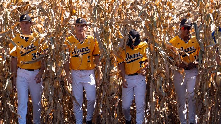 Iowa baseball players enter the field through the cornfield on Oct. 10, 2026, during an exhibition game against Kansas at the Field of Dreams in Dyersville, Iowa.