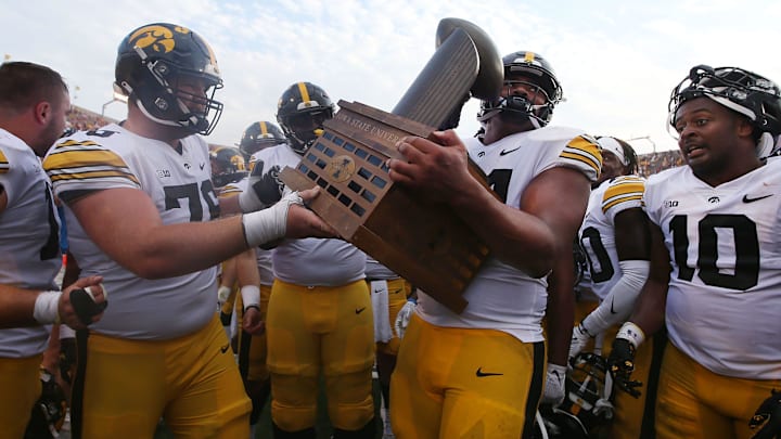 Iowa Football team celebrates with Cy-Hawk trophy after winning 20-13 over Iowa State at the Jack Trice Stadium on Saturday, Sept. 9, 2023, in Ames, Iowa.