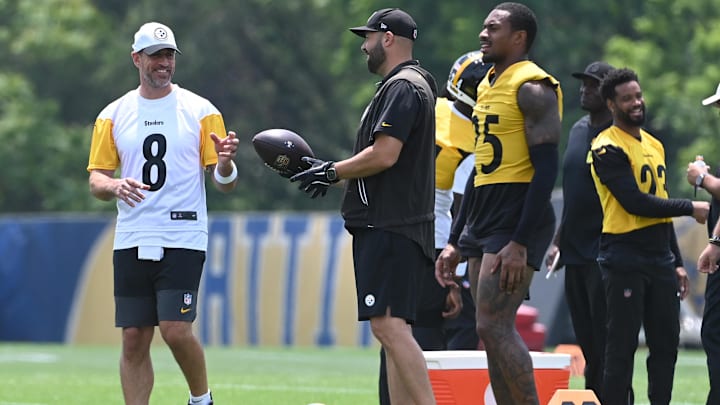 Jun 10, 2025; Pittsburgh, PA, USA; Pittsburgh Steelers quarterback Aaron Rodgers (8) gets the ball during minicamp at their South Side facility. Mandatory Credit: Philip G. Pavely-Imagn Images