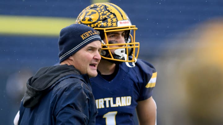Kirtland head coach Tiger LaVerde talks to quarterback Jake LaVerde in the second quarter of play against Versailles in OHSAA Division VI State Championship Game at Tom Benson Hall of Fame Stadium. Friday, December 1, 2023.