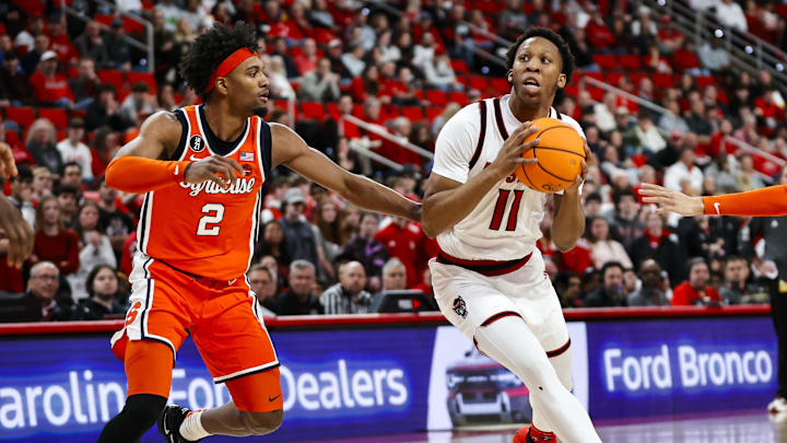Jan 27, 2026; Raleigh, North Carolina, USA; NC State Wolfpack guard Quadir Copeland (11) dribbles with the ball guarded by Syracuse Orange guard Nate Kingz (4) and guard JJ Starling (2) during the first half of the game at Lenovo Center. Mandatory Credit: Jaylynn Nash-Imagn Images Jan 27, 2026; Raleigh, North Carolina, USA; NC State Wolfpack guard Quadir Copeland (11) dribbles with the ball guarded by Syracuse Orange guard Nate Kingz (4) and guard JJ Starling (2) during the first half of the game at Lenovo Center. Mandatory Credit: Jaylynn Nash-Imagn Images