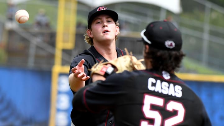 South Carolina pitcher Eli Jones flips the ball to first baseman Gavin Casas to record an out against the Georgia Bulldogs in the 2023 SEC Baseball Tournament South Carolina pitcher Eli Jones flips the ball to first baseman Gavin Casas to record an out against the Georgia Bulldogs in the 2023 SEC Baseball Tournament