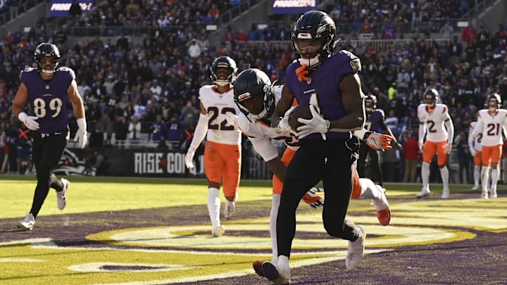 Nov 3, 2024; Baltimore, Maryland, USA; Baltimore Ravens wide receiver Zay Flowers (4) catches a pass for a touchdown in front of Denver Broncos cornerback Riley Moss (21) during the first half at M&T Bank Stadium. Mandatory Credit: Tommy Gilligan-Imagn Images Nov 3, 2024; Baltimore, Maryland, USA; Baltimore Ravens wide receiver Zay Flowers (4) catches a pass for a touchdown in front of Denver Broncos cornerback Riley Moss (21) during the first half at M&T Bank Stadium. Mandatory Credit: Tommy Gilligan-Imagn Images