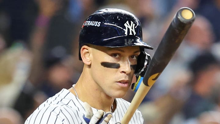 Oct 7, 2025; Bronx, New York, USA; New York Yankees outfielder Aaron Judge (99) flips his bat after hitting a three-run home run in the fourth inning against the Toronto Blue Jays during game three of the ALDS round for the 2025 MLB playoffs at Yankee Stadium. Mandatory Credit: Wendell Cruz-Imagn Images