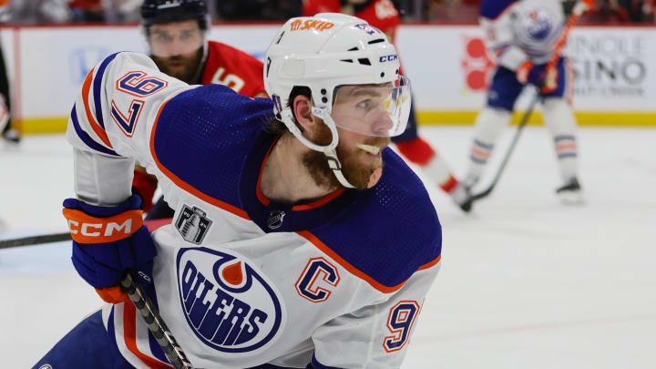 Jun 8, 2024; Sunrise, Florida, USA; Edmonton Oilers forward Connor McDavid (97) plays the puck against the Florida Panthers during the third period in game one of the 2024 Stanley Cup Final at Amerant Bank Arena. Mandatory Credit: Sam Navarro-USA TODAY Sports