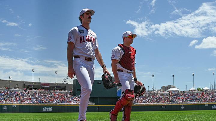 Jun 13, 2026; Omaha, NE, USA;  Alabama Crimson Tide starting pitcher Tyler Fay (8) and catcher Brady Neal (10) walk to the dugout before the game against the Oklahoma Sooners at Charles Schwab Field. Mandatory Credit: Steven Branscombe-Imagn Images