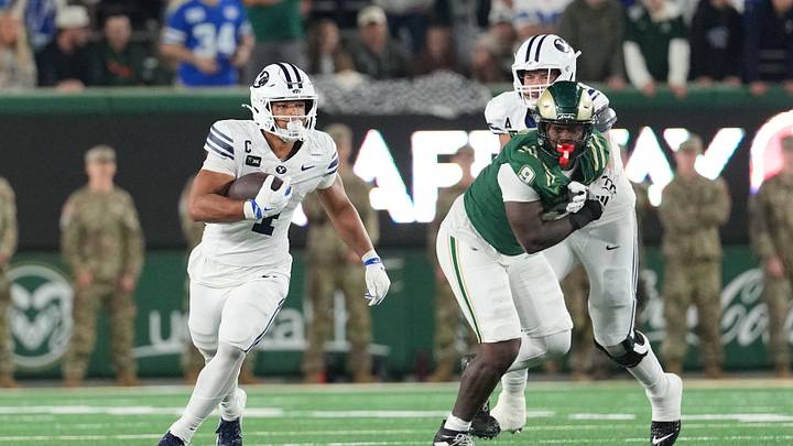 Sep 19, 2026; Fort Collins, Colorado, USA;  BYU Cougars running back Lj Martin (4) runs the ball past Colorado State Rams defensive lineman Stephon Wright (9) at Sonny Lubick Field at Canvas Stadium.  Mandatory Credit: Andrew Rydland-Imagn Images