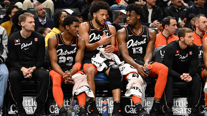 Mar 22, 2024; Detroit, Michigan, USA; Detroit Pistons guard Cade Cunningham (2) (center) talks with guard Jaden Ivey (23) (left) and center James Wiseman (13) on the bench in the first quarter of their game against the Boston Celtics at Little Caesars Arena. Mandatory Credit: Lon Horwedel-Imagn Images Mar 22, 2024; Detroit, Michigan, USA; Detroit Pistons guard Cade Cunningham (2) (center) talks with guard Jaden Ivey (23) (left) and center James Wiseman (13) on the bench in the first quarter of their game against the Boston Celtics at Little Caesars Arena. Mandatory Credit: Lon Horwedel-Imagn Images