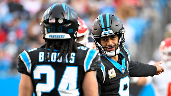 Nov 24, 2024; Charlotte, North Carolina, USA;  Carolina Panthers quarterback Bryce Young (9) talks to running back Jonathon Brooks (24) in the fourth quarter at Bank of America Stadium. Mandatory Credit: Bob Donnan-Imagn Images