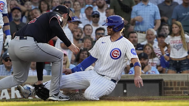 Chicago, Illinois, USA; Cleveland Guardians pitcher Gavin Williams (32) tags out Chicago Cubs catcher Carson Kelly (15) at home plate during the second inning at Wrigley Field.