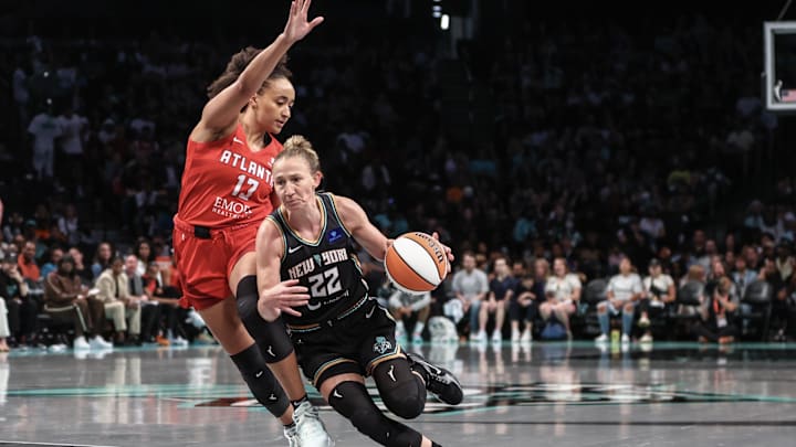 Sep 22, 2024; Brooklyn, New York, USA; New York Liberty guard Courtney Vandersloot (22) drives past Atlanta Dream guard Haley Jones (13) during game one of the first round of the 2024 WNBA Playoffs at Barclays Center. Mandatory Credit: Wendell Cruz-Imagn Images Sep 22, 2024; Brooklyn, New York, USA; New York Liberty guard Courtney Vandersloot (22) drives past Atlanta Dream guard Haley Jones (13) during game one of the first round of the 2024 WNBA Playoffs at Barclays Center. Mandatory Credit: Wendell Cruz-Imagn Images