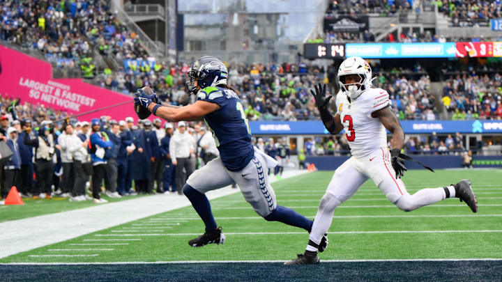 Nov 24, 2024; Seattle, Washington, USA; Seattle Seahawks wide receiver Jaxon Smith-Njigba (11) scores a touchdown while defended by Arizona Cardinals safety Budda Baker (3) during the first half at Lumen Field. Mandatory Credit: Steven Bisig-Imagn Images