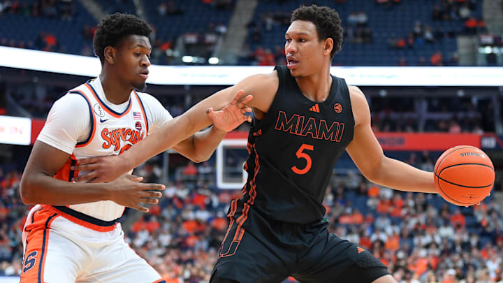 Jan 24, 2026; Syracuse, New York, USA; Miami Hurricanes forward Malik Reneau (5) drives against Syracuse Orange forward Tyler Betsey (5) during the first half at the JMA Wireless Dome. Mandatory Credit: Rich Barnes-Imagn Images