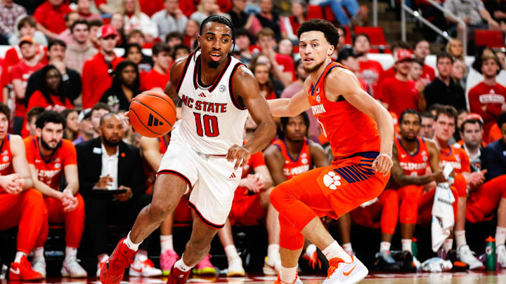 Feb 1, 2025; Raleigh, North Carolina, USA; North Carolina State Wolfpack guard Marcus Hill (10) dribbles with the ball guarded by Clemson Tigers guard Chase Hunter (1) during the first half of the game at Lenovo Center. Feb 1, 2025; Raleigh, North Carolina, USA; North Carolina State Wolfpack guard Marcus Hill (10) dribbles with the ball guarded by Clemson Tigers guard Chase Hunter (1) during the first half of the game at Lenovo Center.