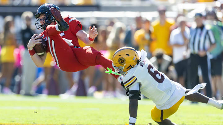 Oct 18, 2025; Tempe, Arizona, USA; Texas Tech Red Raiders quarterback Will Hammond (15) is upended by Arizona State Sun Devils safety Adrian Wilson (6) in the first half at Mountain America Stadium. Mandatory Credit: Mark J. Rebilas-Imagn Images